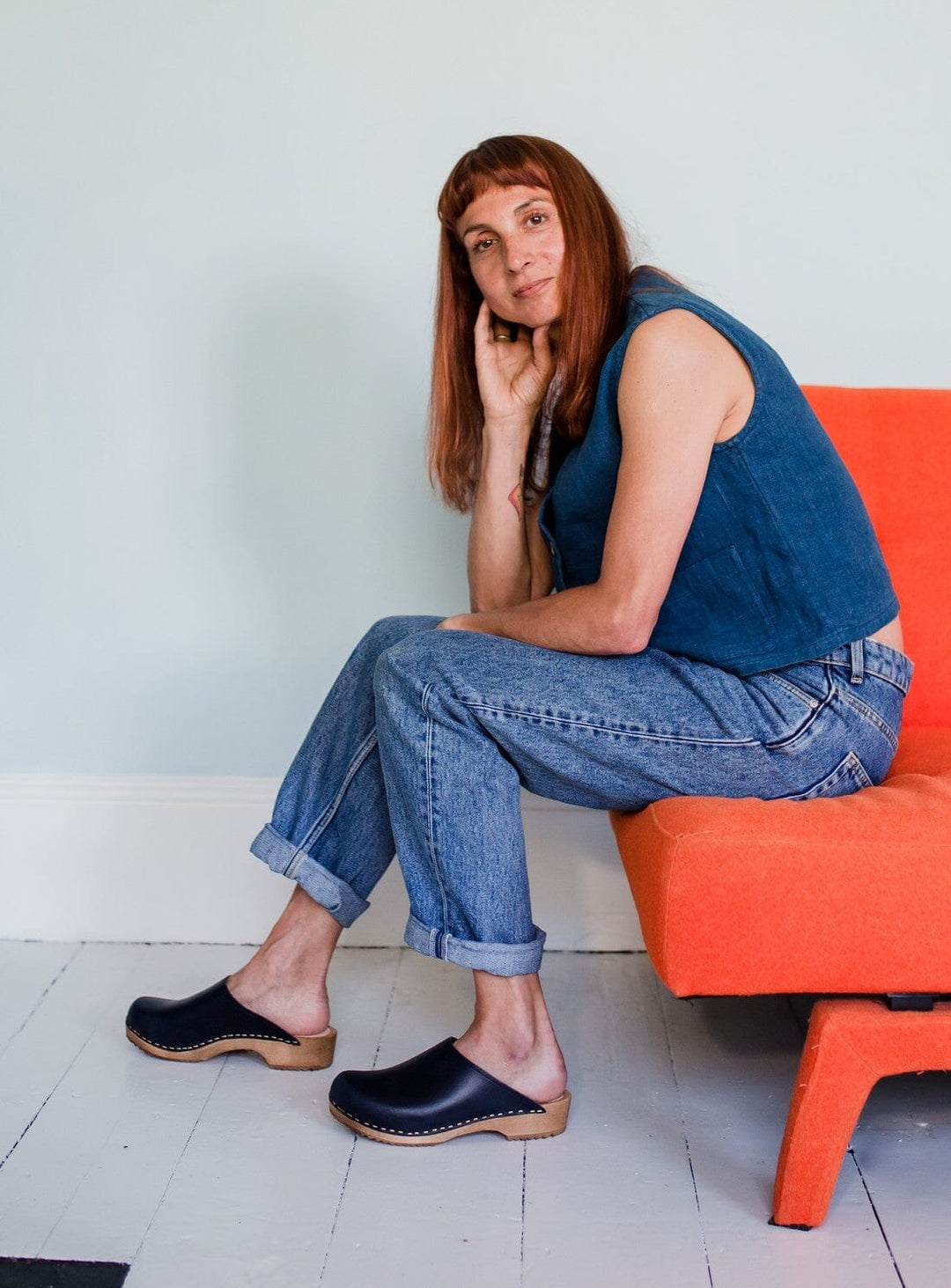 Low Klassisk Clog in Indigo from KIT + CLOGS worn by a model wearing cuffed jeans and a denim waistcoat