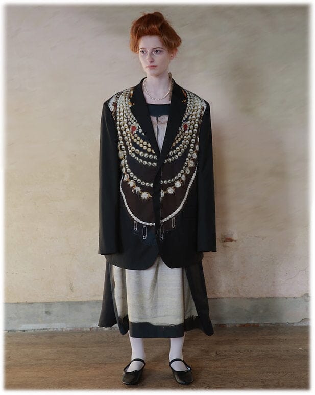 Model wearing Petticoat Sculptural Skirt with blazer from  IA London 